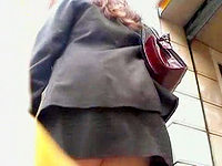 Though this babe is wearing the strict suit her skirt is so short that it is possible to catch her upskirt panty view!